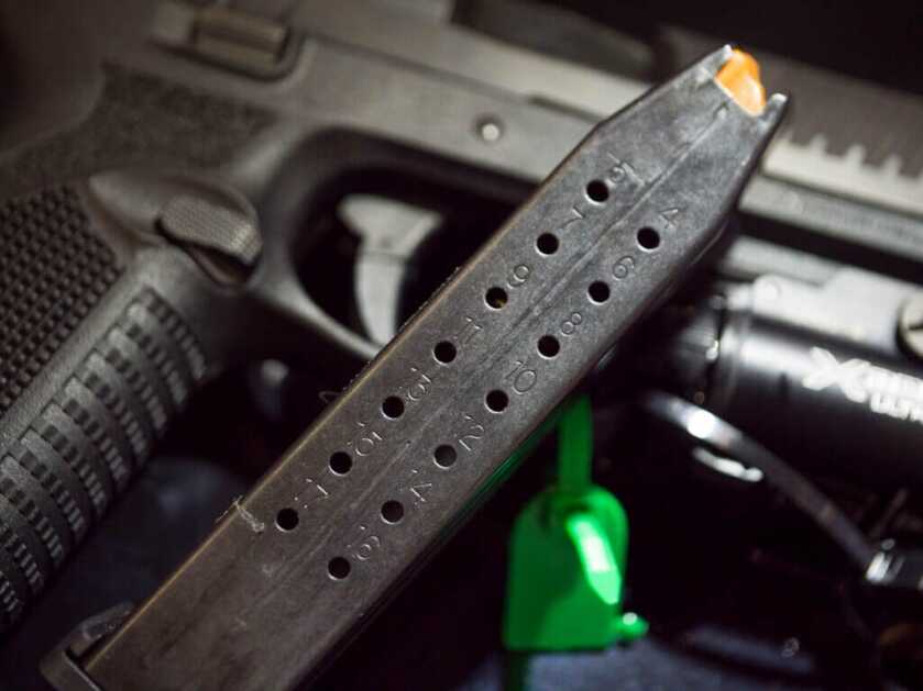 Close up view of the back of the magazine showing the holes for each round. The 509 is in the background.