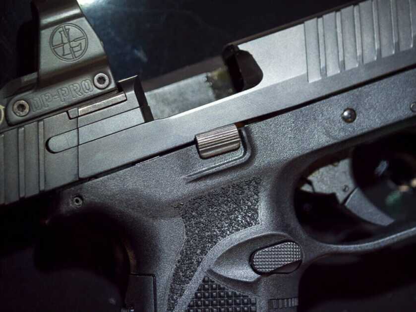 Close up view of the right side of the gun. The slide is open and the ejection port is revealed.