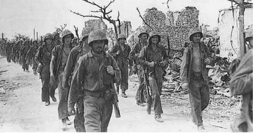 soldiers marching with guns slung over their sholders