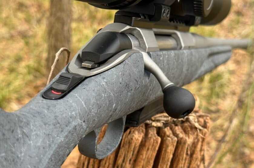 Ruger rifle bolt action sitting on fence post