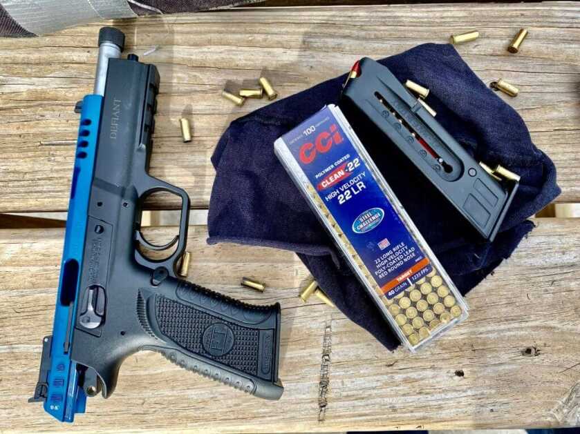 Force 22 TB on a wooden table with a magazine and 22 LR ammo