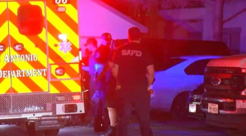 Emergency personnel responding to crime scene with bright lights and ambulence