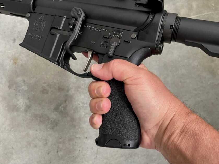 man holding AR15 in hand