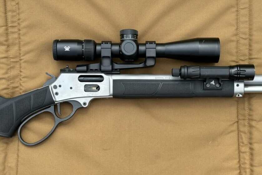 the Viper HD 3-15 is mounted on a S&W 1854 and laid on brown canvas