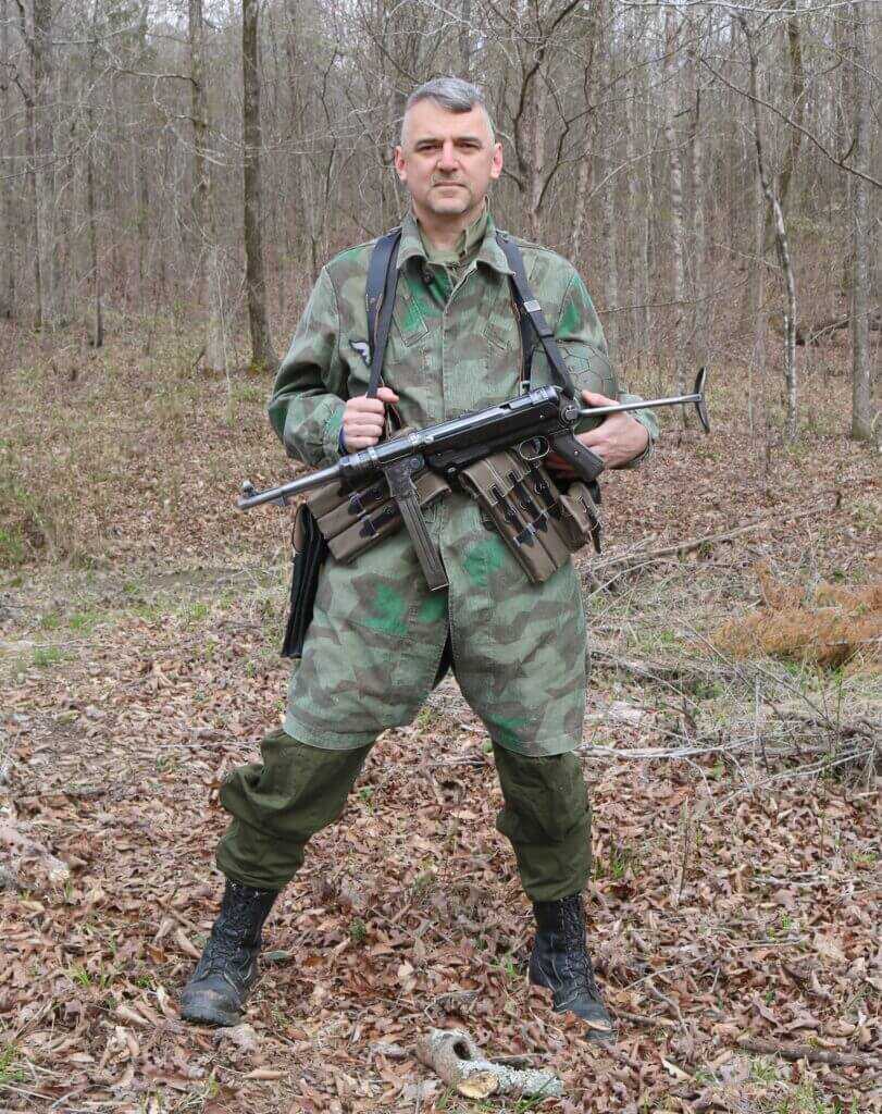 Man in camo holding vintage gun