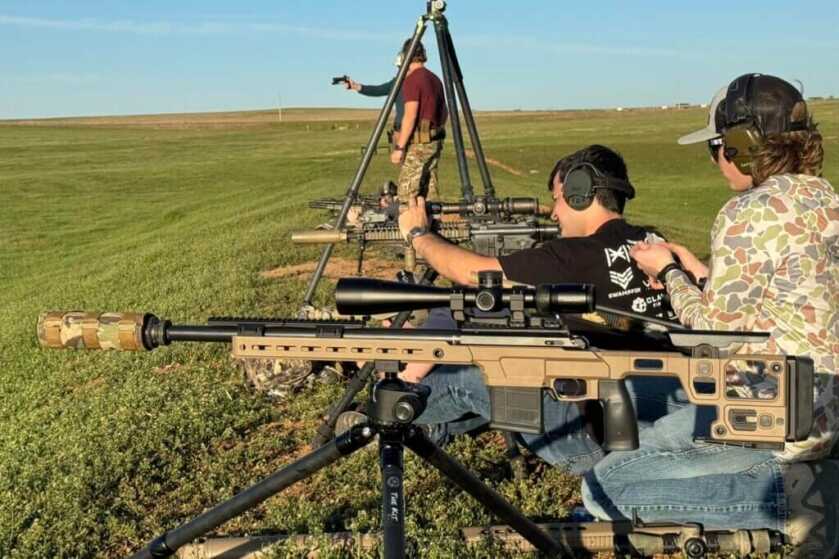 men shooting rifles at a range