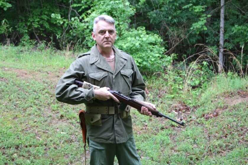 White-haired soldier holding M1 Carbine