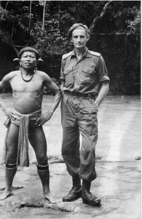 Soldier standing by river wither Japanese native