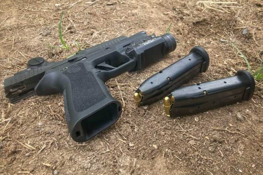 Sig Sauer P320XF with magazines on the ground