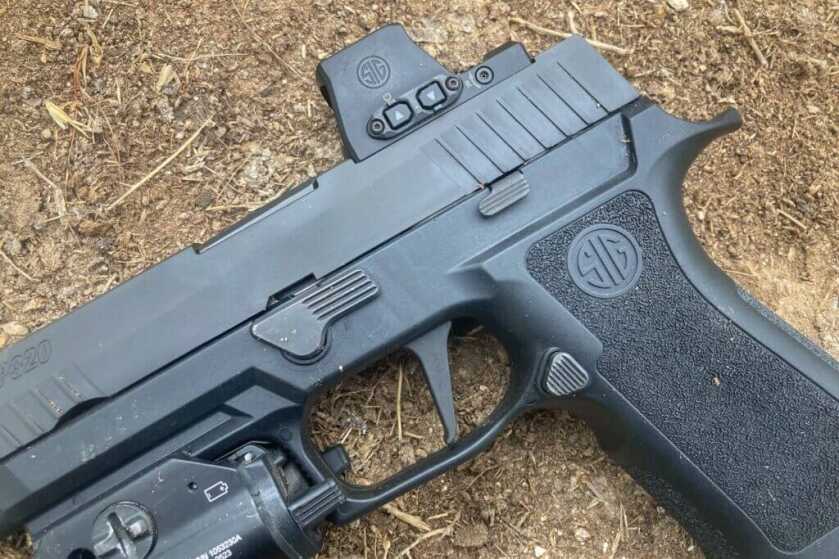 Sig Sauer pistol on the ground