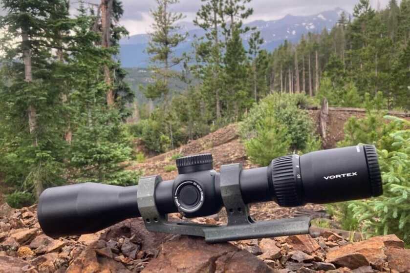 Vortex Viper HD 2-10x42 in mountain forest sitting on rugged red rock pile