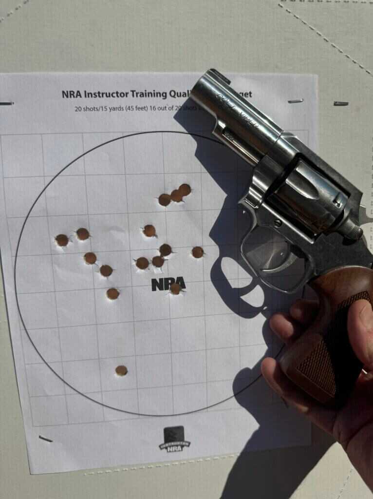 Colt Viper revolver next to paper NRA target