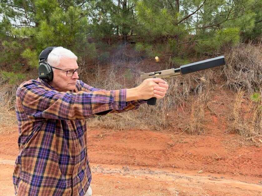 Man shooting suppressed FN 545 Tactical