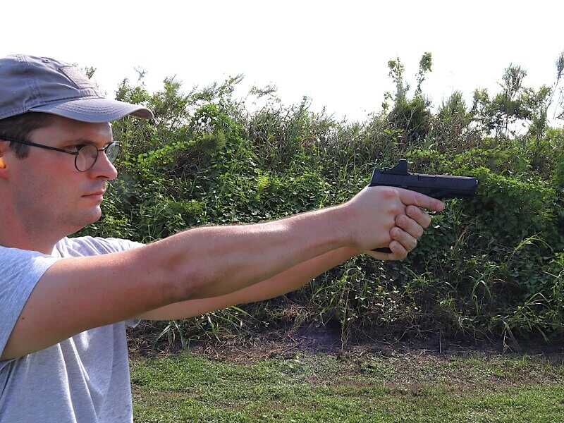 man shooting semi-auto pistol