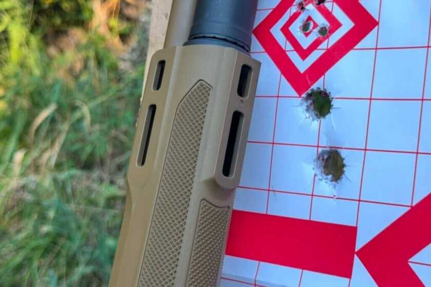 m-lok on a shotgun in front of paper target