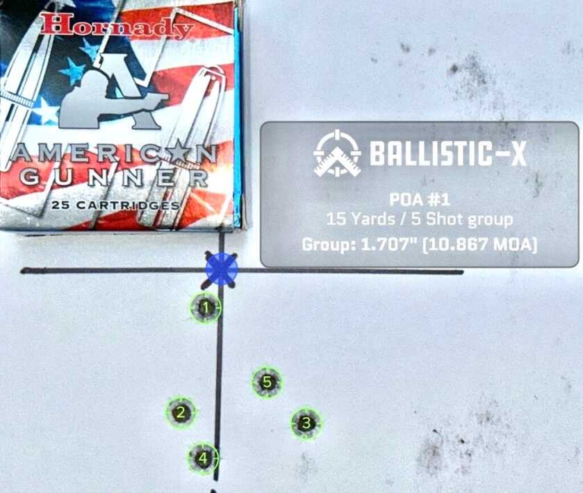 A used pistol target with a box of ammunition on top shows how accurate it is.