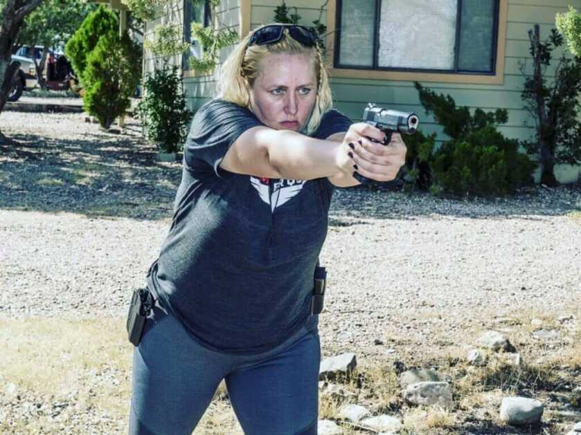 woman aiming a gun in self-defense