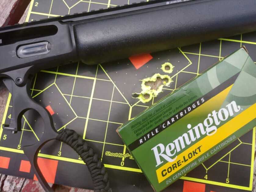 lever-action rifle with ammunition on bench showing deer-ready accuracy