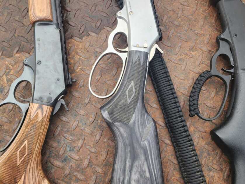 lever-action rifles showing different loop levers and classic hunting setup