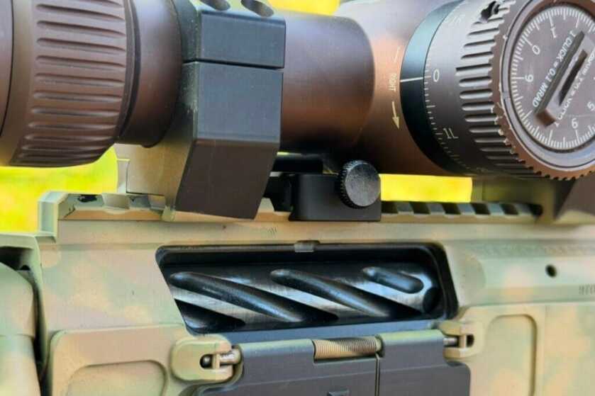close up of tan rifle and scope