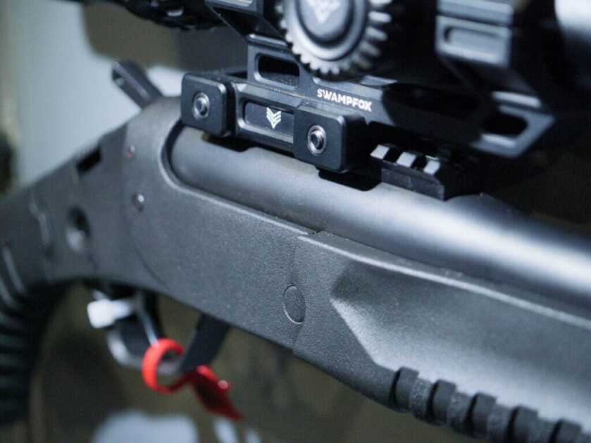 Close up of the Picatinny rail with a scope mounted.