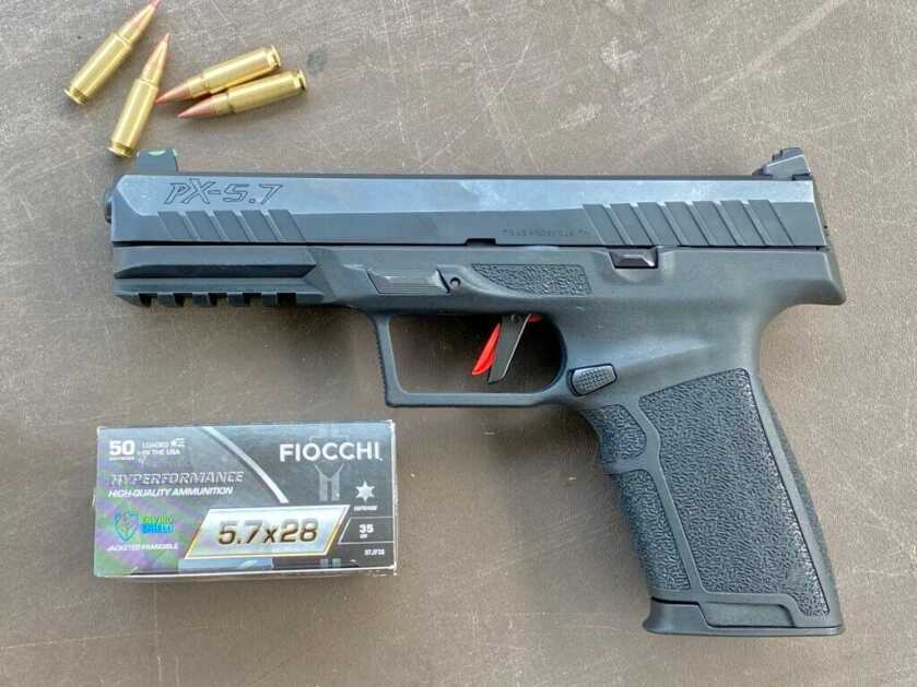 Handgun with box of Fiocchi 5.7x28mm ammo