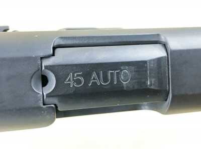 The small hole is a chamber status indicator. You can see, but not feel, if there is a cartridge in there.