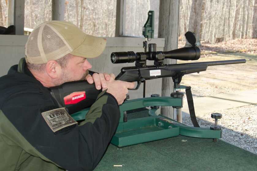 Shooter testing a Savage B17 FV 17 HMR rifle with a Burris scope at the range