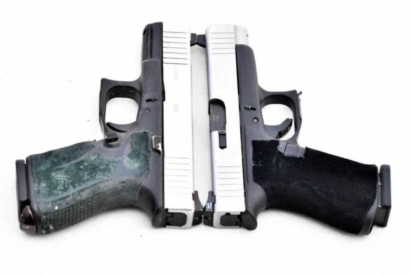 Two Glock Slimline pistols with silver slides side by side