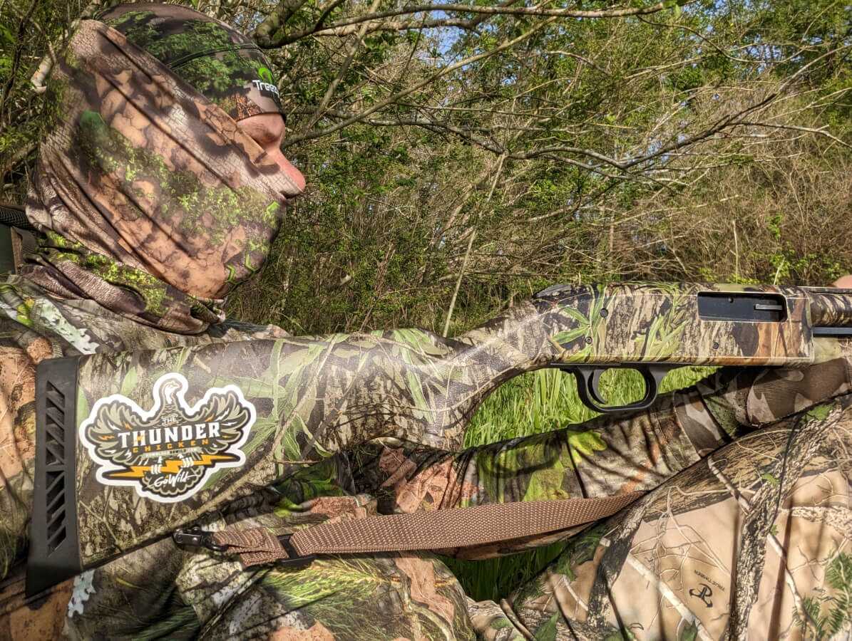 Hunter in camo with a Mossberg 500 Turkey 20 gauge shotgun