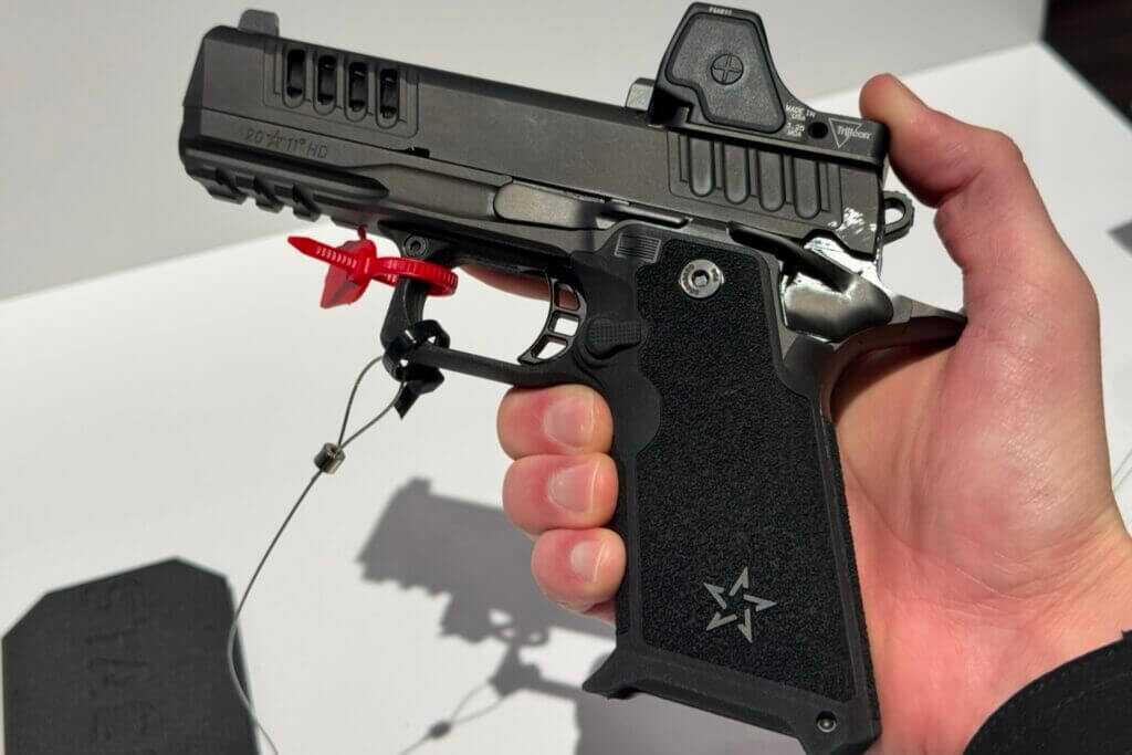 Shooter's hand gripping a Staccato HD pistol showing the HD grip texture and beavertail