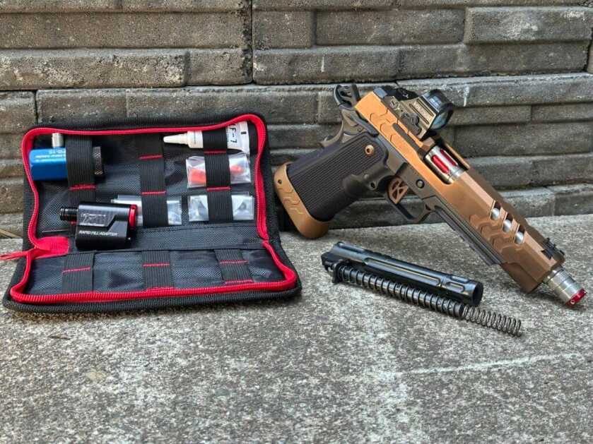 A toolkit full of components sits next to a bronze and black two-tone 2011.