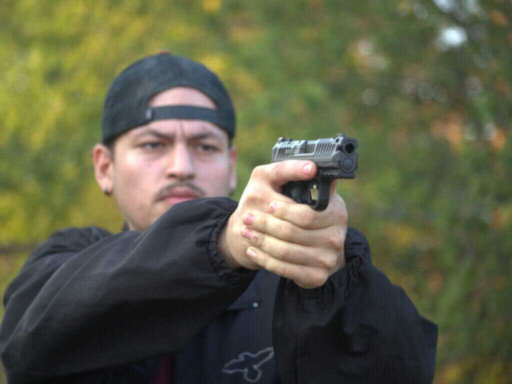 man aiming handgun