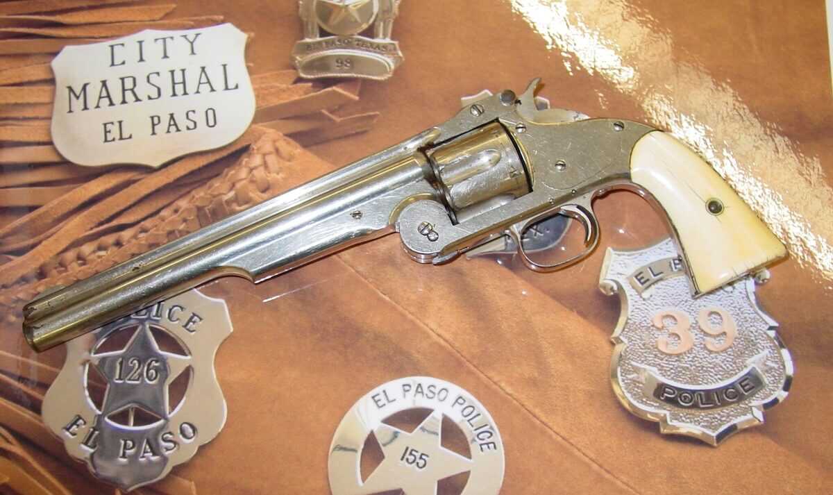 Nickel Smith and Wesson Model 3 top-break revolver displayed with El Paso City Marshal badges