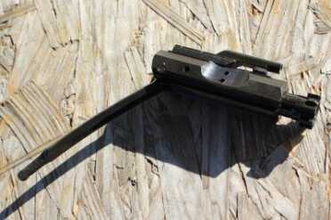 The bolt carrier group with its tail showing. 