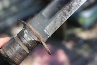 Kill-a-Bear with a Ka-Bar Knife? Someone attacked this blade with a file in an effort to sharpen it, and they didn't file off a new secondary edge. Instead, they ran it up the original grind lines.