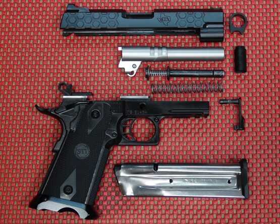 Components of the 2011 Hex Tactical include full length guide rod with internal and external springs. Barrel is secured out front with a short bushing.