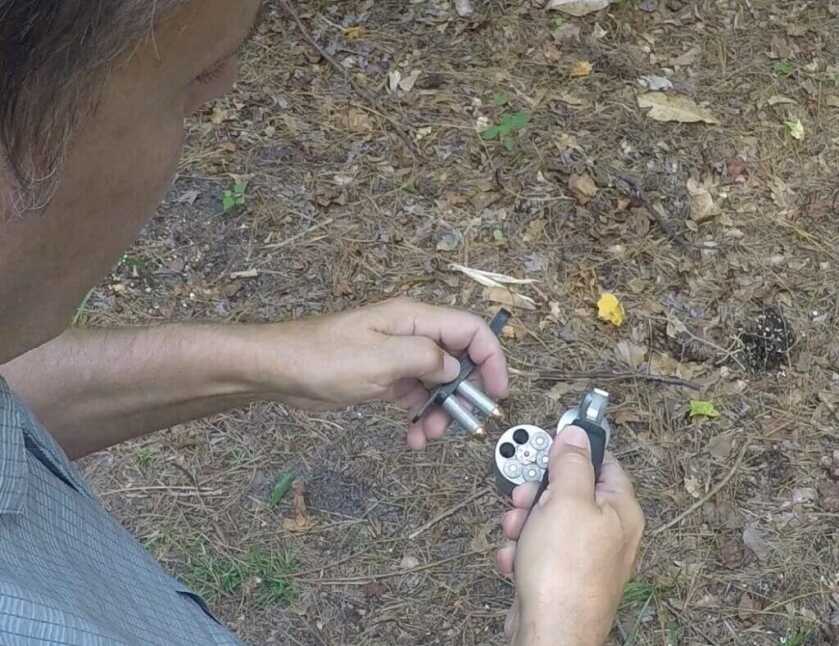 Man loading ammo into revolver