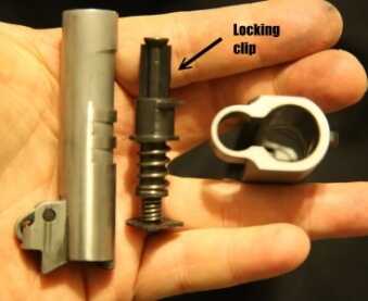 The takedown system on the EMP is a little strange. You have to lock the slide open before removing it so you can install this black plastic clip on the front of the guide rod. This allows you to take the spring out without fighting the tension, then the barrel just slides out the front like a regular 1911. 