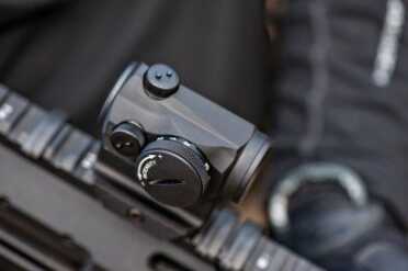 View of Aimpoint H-1 windage and elevation as well as the brightness adjustment knob.