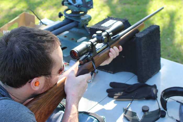 Shooter firing the CZ 557 Sporter .30-06 deer rifle from a rest