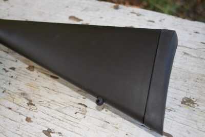 The stock has a fixed sling attachment point and a soft rubber recoil pad.