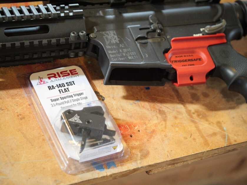 RISE Armament RA-140 drop-in trigger being installed in an AR-15 lower, best AR trigger under 150 2026