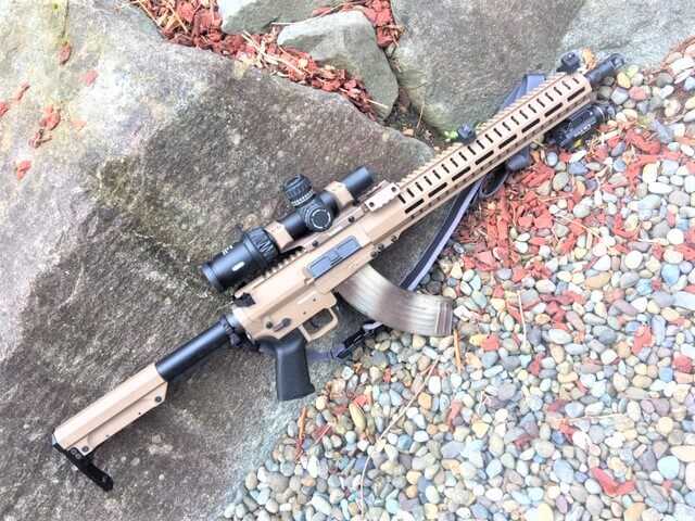 CMMG Mk47 Mutant 7.62x39 rifle with scope on rocks