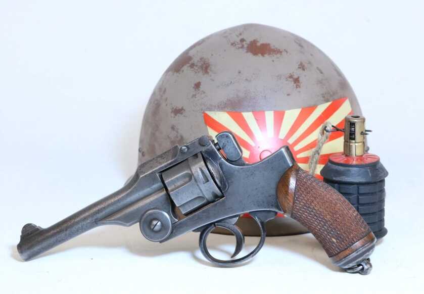 Japanese Type 26 top-break revolver with a WWII helmet and grenade