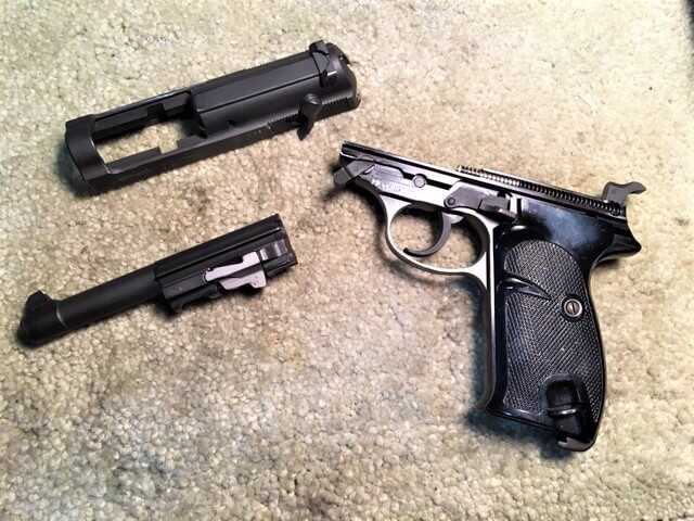 Walther P1 field stripped into slide, barrel and frame