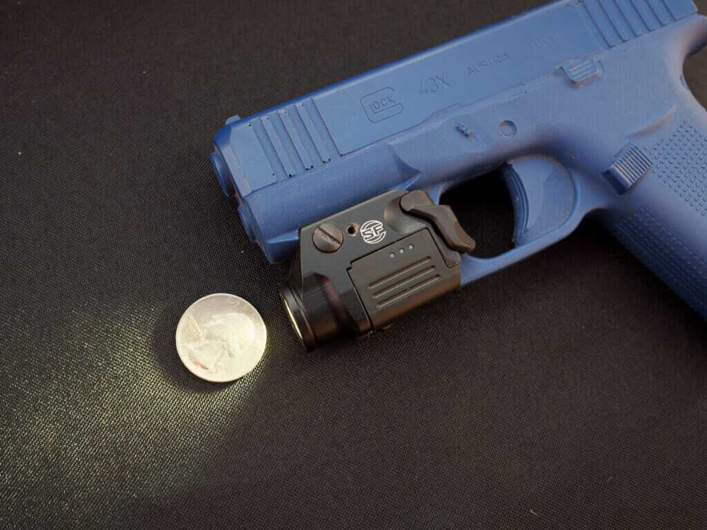Surefire XSC micro handgun light with rechargeable proprietary battery shown on display