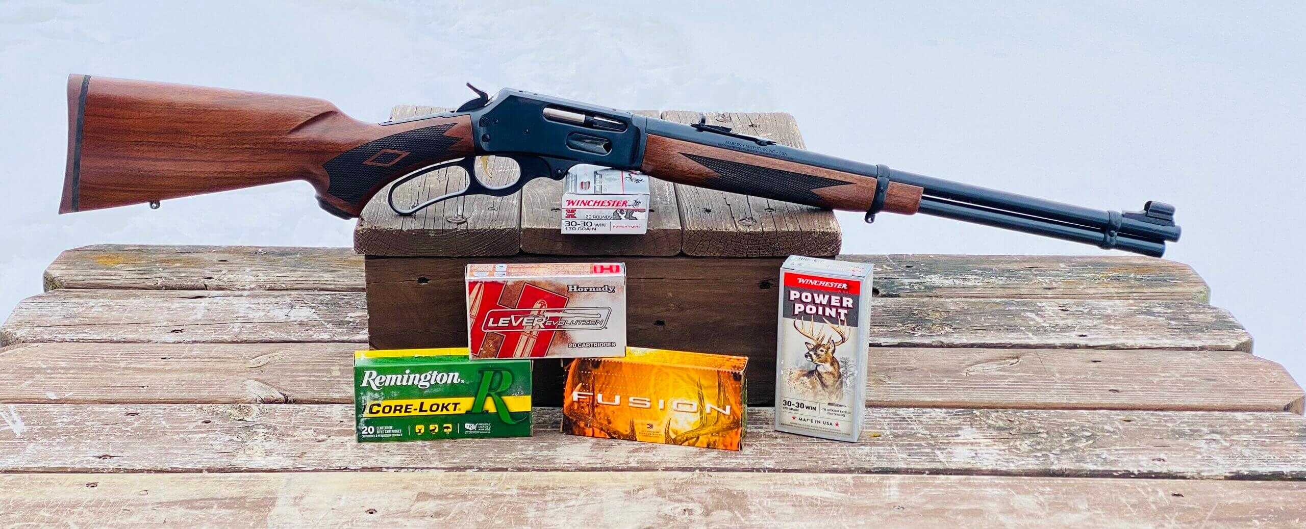 Marlin 336 Classic .30-30 lever action with boxes of Remington, Federal, and Winchester ammunition