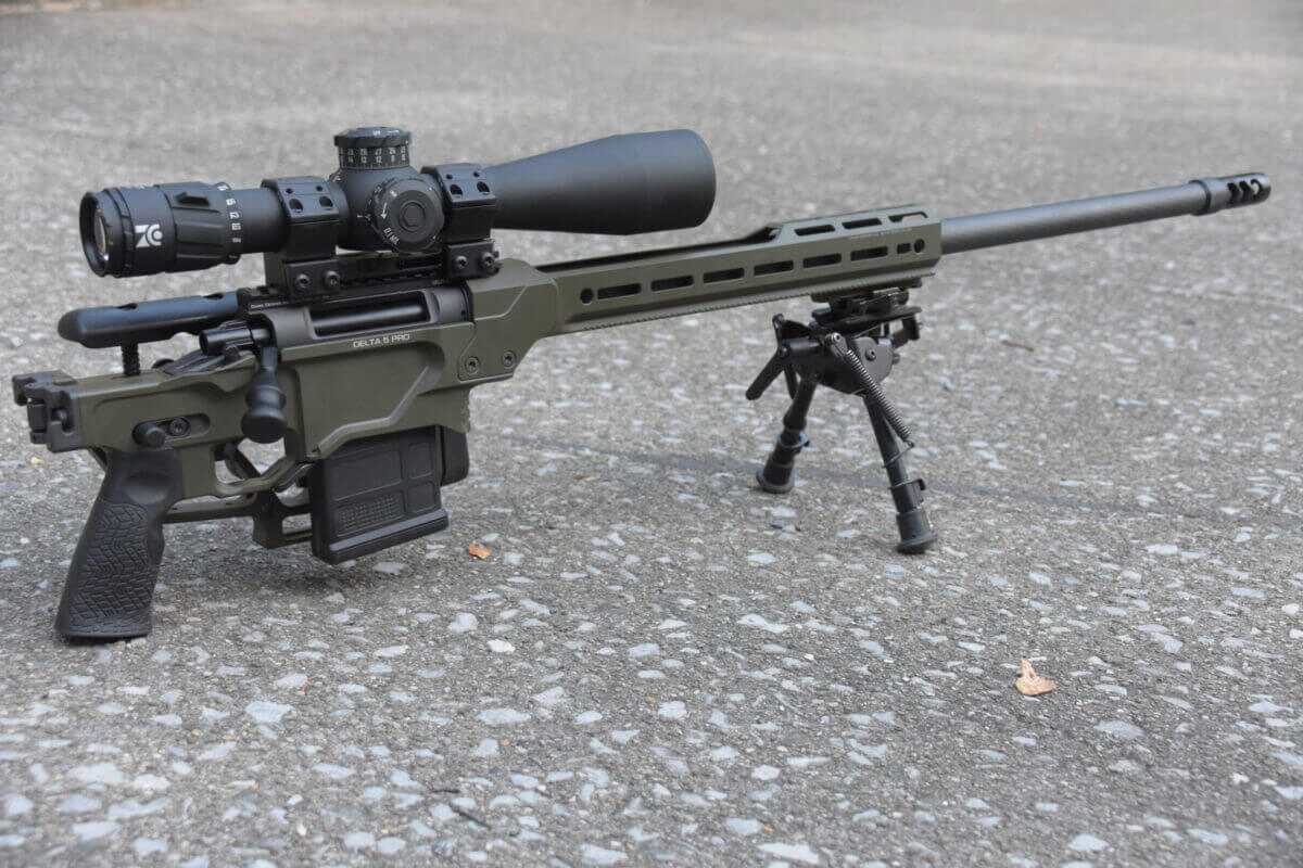 The Daniel Defense Delta 5 Pro has its stock folded and is laying on a concrete pad.