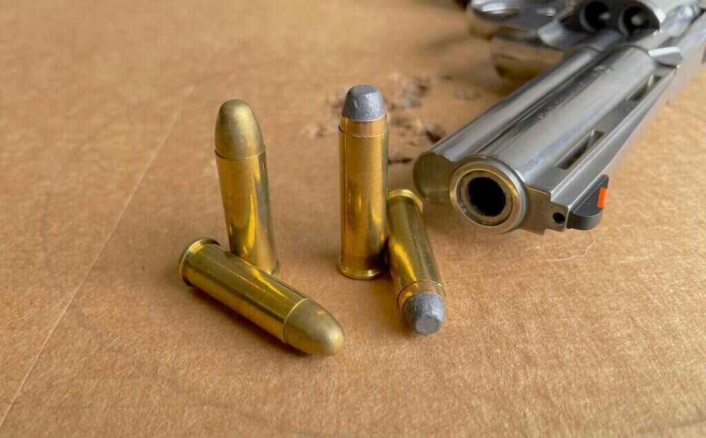 .38 Special and .357 Magnum cartridges beside a revolver muzzle